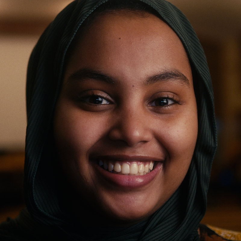 High school female student looking directly into camera.
