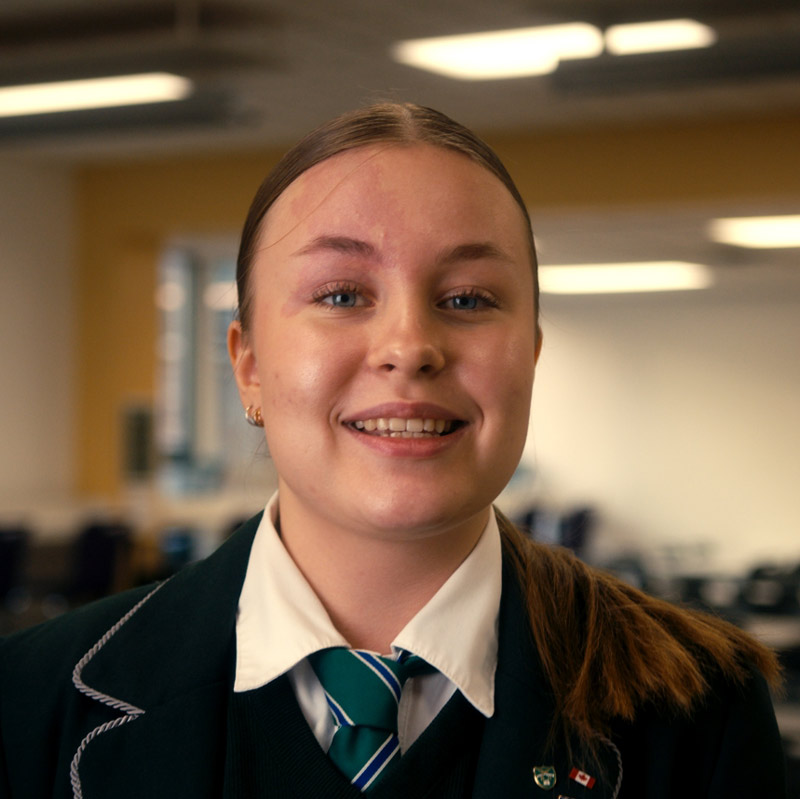 High school female student looking directly into camera.