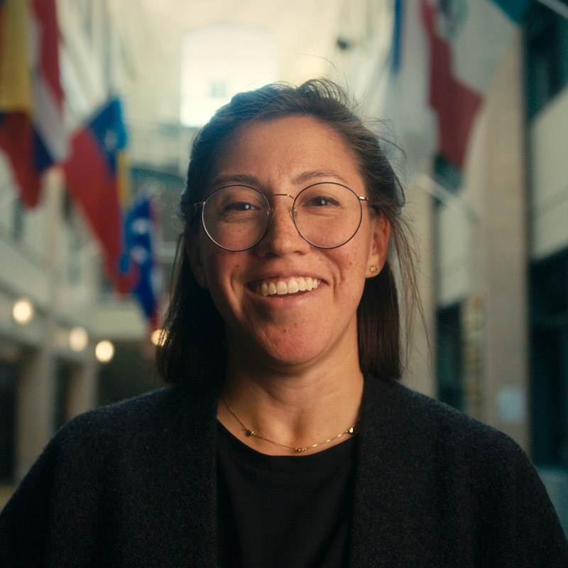Female teacher looking directly into camera.